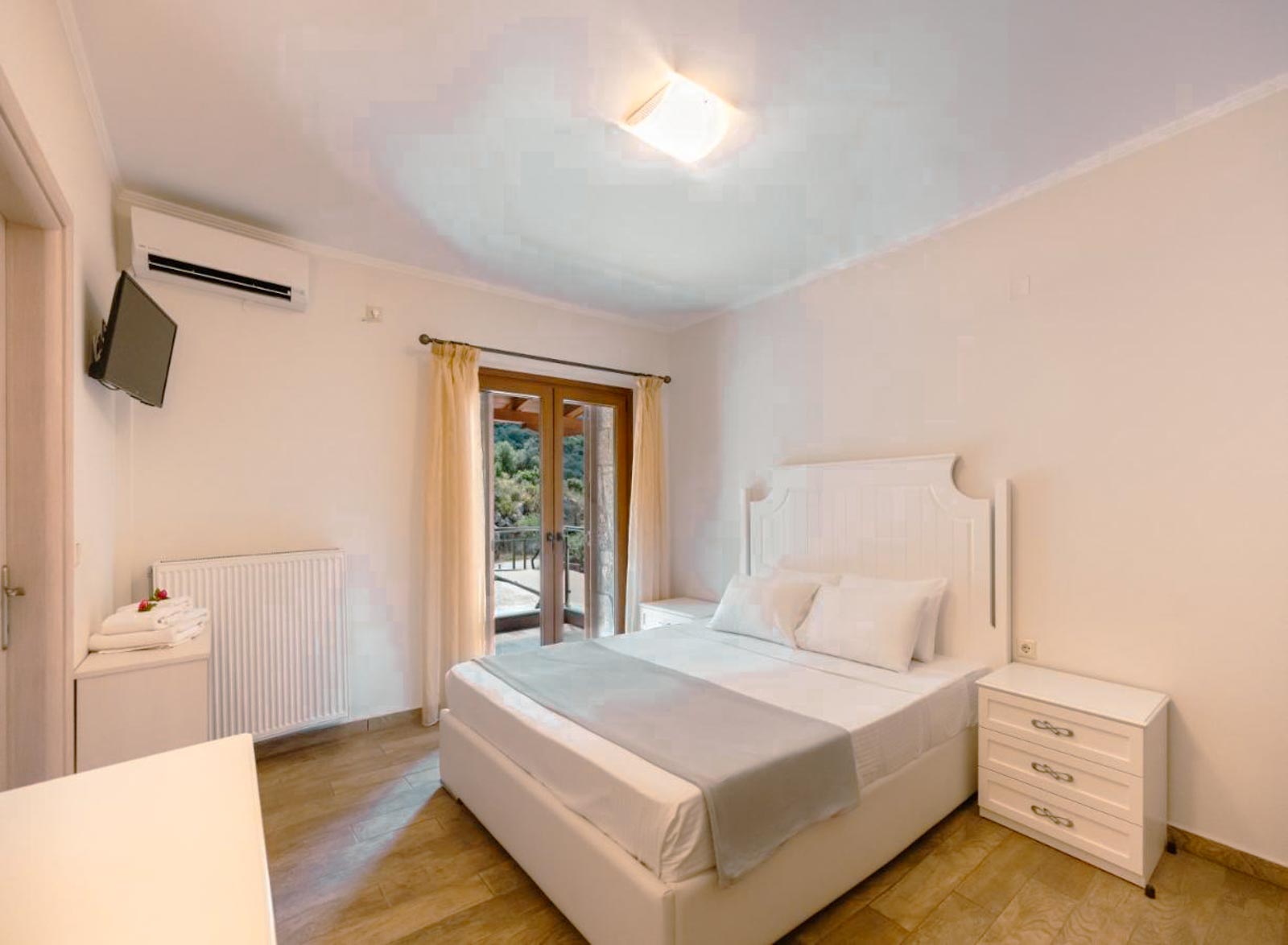 Bright White Bedroom with Balcony Access